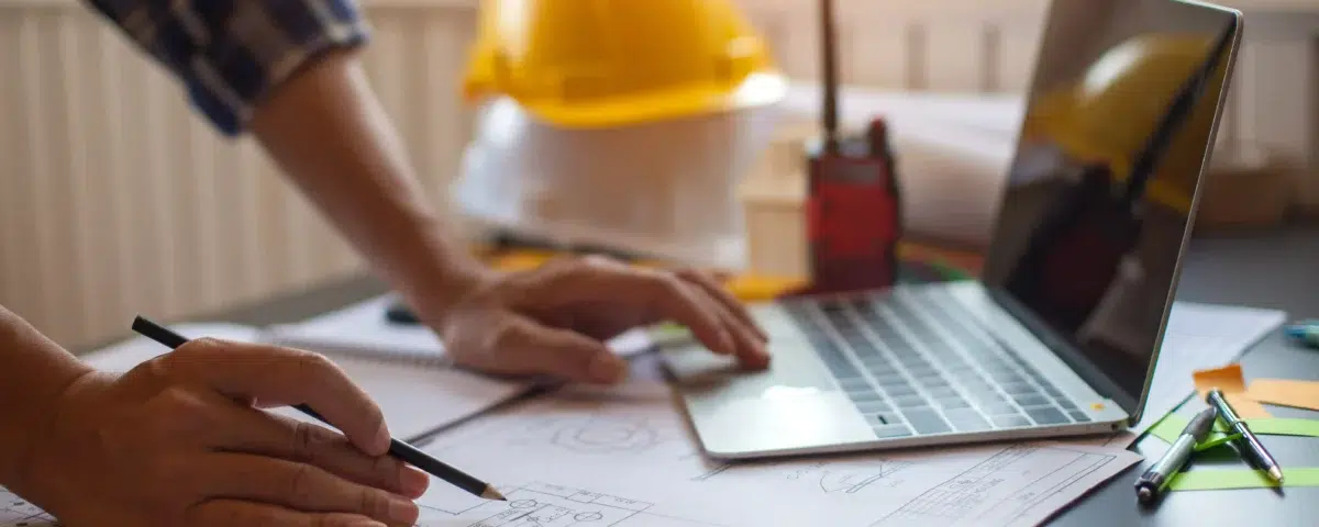 A construction worker looks over a blueprint for a current project