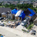 A Florida home with severe hurricane roof damage covered by emergency tarps following a major storm.